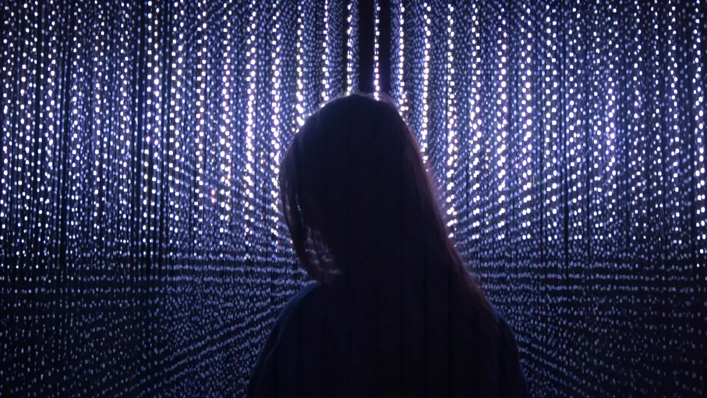 Figure silhouetted against an LED curtain